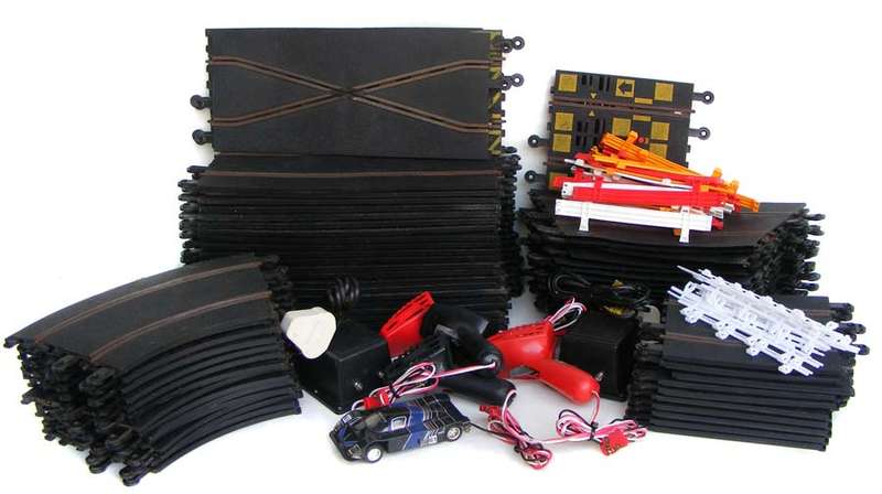 Bargain lot of 64 Scalextric slot car tracks, 2 transformers, 4 controllers, railings, car
