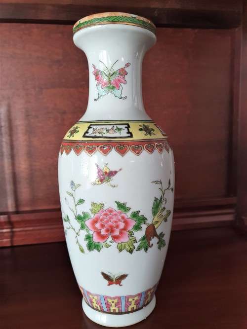 HANDPAINTED CHINESE PORCELAIN VASE, FILLED WITH CONTENTS STILL INSIDE.