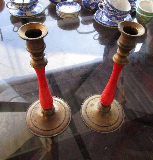 PAIR RED AND BRASS CANDLESTICKS