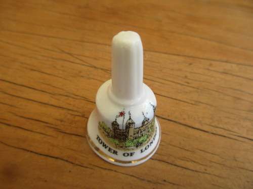 COLLECTION OF FOUR MINIATURE CHINA BELLS ENGLAND