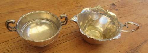 A TWIN HANDLED BOWL ( WALKER AND HALL) AND A CREAMER JUG SILVER PLATED