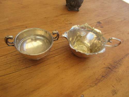 A TWIN HANDLED BOWL ( WALKER AND HALL) AND A CREAMER JUG SILVER PLATED
