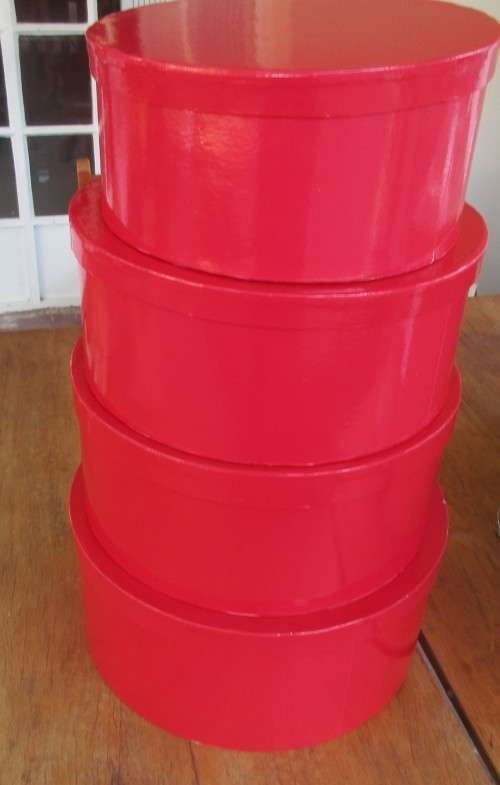 SET OF FOUR FIRE ENGINE RED  CIRCULAR BOXES THEY ALL FIT INTO EACH OTHER