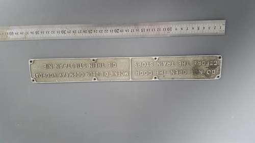 Train "do not open the door" floor plate sign.