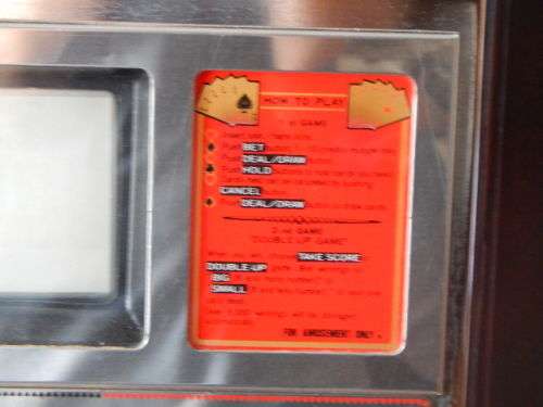A VINTAGE GOLDEN POKER GAMBLING MACHINE