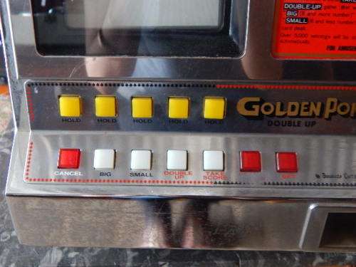 A VINTAGE GOLDEN POKER GAMBLING MACHINE