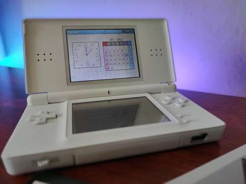 Nintendo ds lite (white) with 4 game cartridges