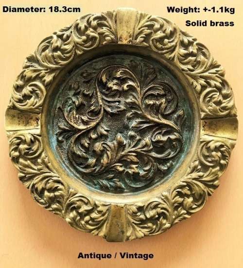 A very ornate, extremely heavy brass ashtray for it`s size. Diameter  17.5mm. Weight  +-1.1kg