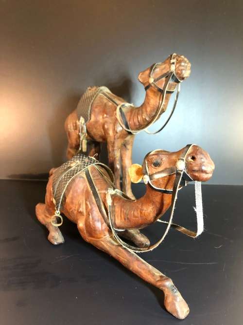 A PAIR OF MORROCAN LEATHER CAMEL FIGURINES