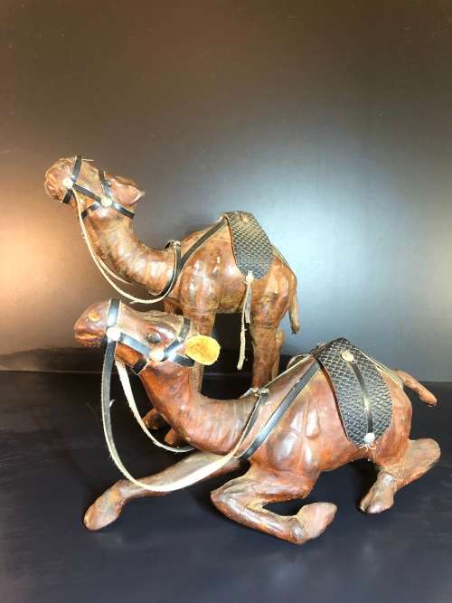 A PAIR OF MORROCAN LEATHER CAMEL FIGURINES