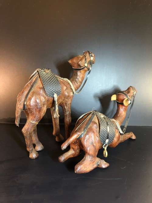 A PAIR OF MORROCAN LEATHER CAMEL FIGURINES
