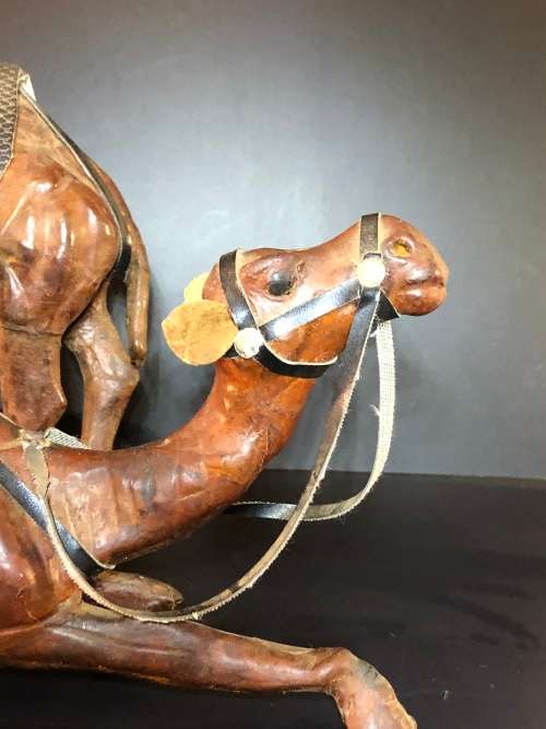 A PAIR OF MORROCAN LEATHER CAMEL FIGURINES