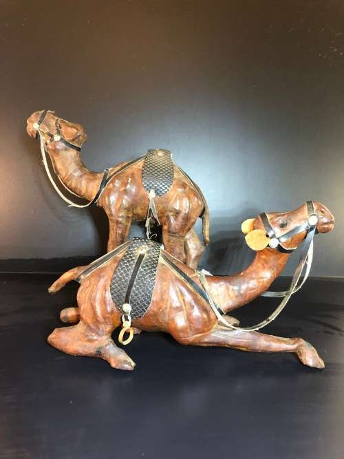A PAIR OF MORROCAN LEATHER CAMEL FIGURINES