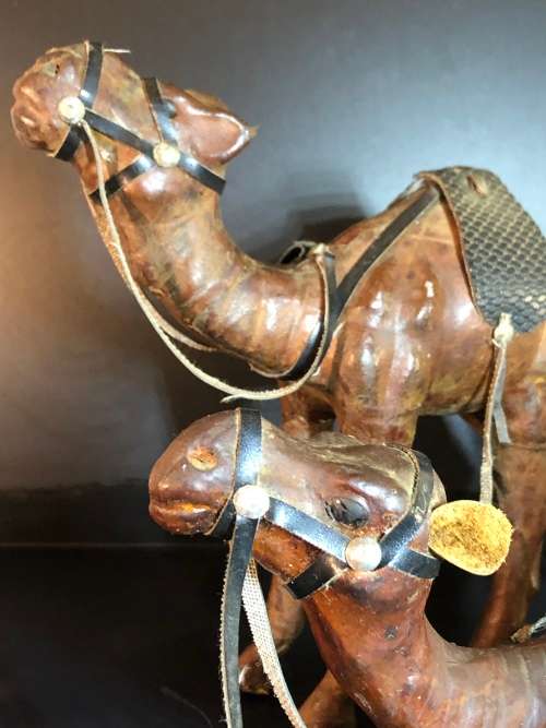 A PAIR OF MORROCAN LEATHER CAMEL FIGURINES
