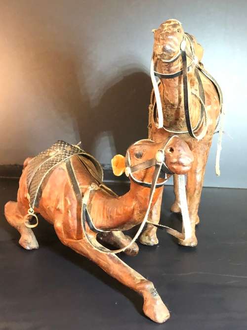 A PAIR OF MORROCAN LEATHER CAMEL FIGURINES