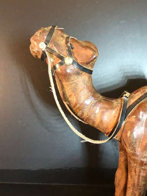 A PAIR OF MORROCAN LEATHER CAMEL FIGURINES
