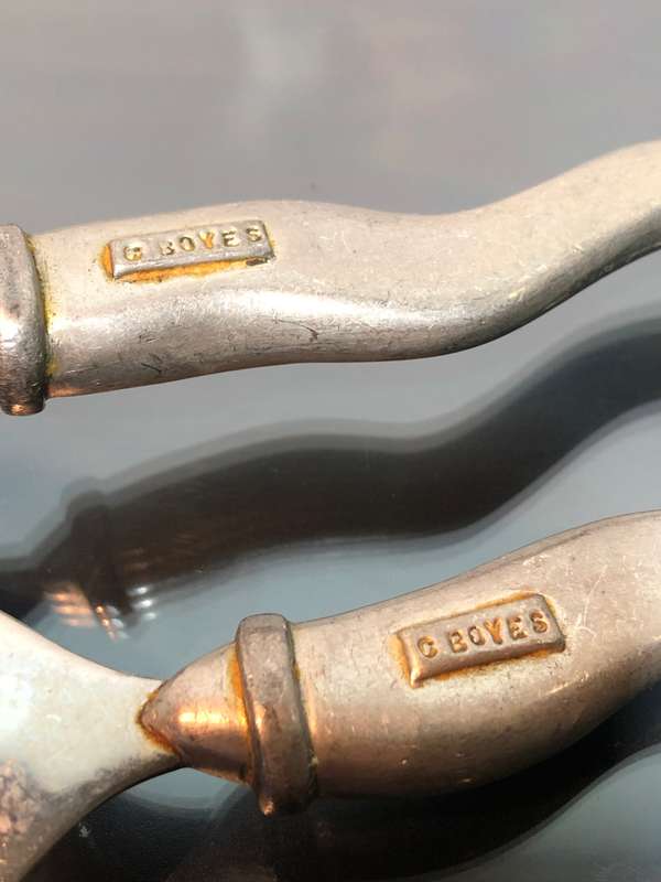 A set of Carol Boyes Wave Salad Spoons and a Larger Serving Spoon