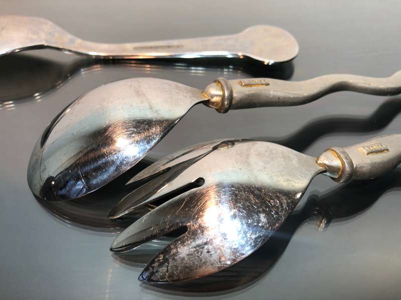 A set of Carol Boyes Wave Salad Spoons and a Larger Serving Spoon