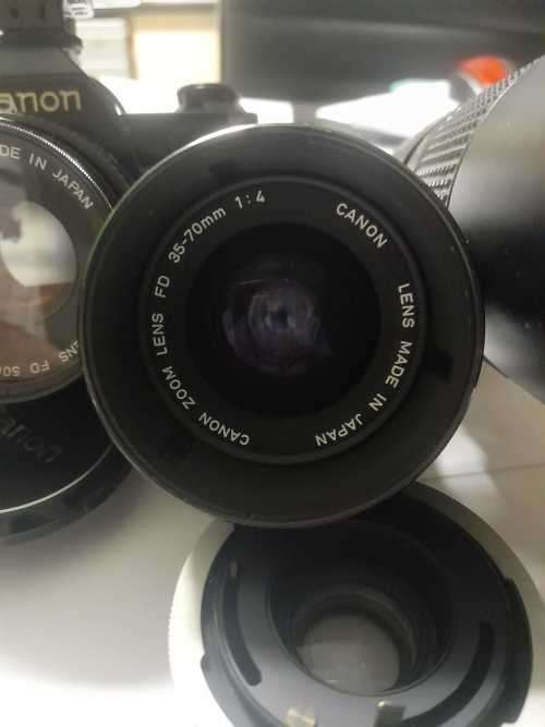 Canon AE1 35mm SLR Film Camera Black camera with 4 lenses. The camera and lenses look to be in very