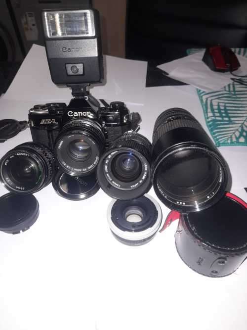 Canon AE1 35mm SLR Film Camera Black camera with 4 lenses. The camera and lenses look to be in very