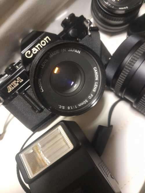 Canon AE1 35mm SLR Film Camera Black camera with 4 lenses. The camera and lenses look to be in very