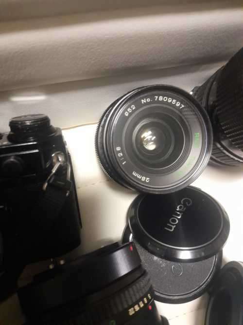 Canon AE1 35mm SLR Film Camera Black camera with 4 lenses. The camera and lenses look to be in very