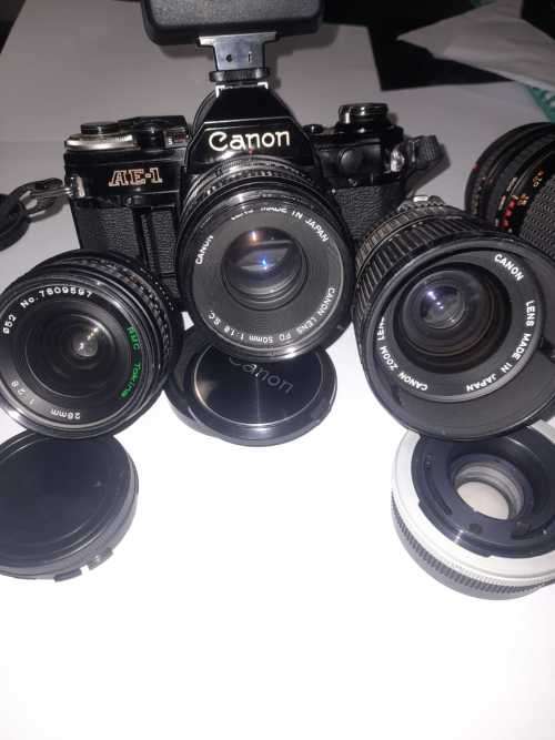Canon AE1 35mm SLR Film Camera Black camera with 4 lenses. The camera and lenses look to be in very