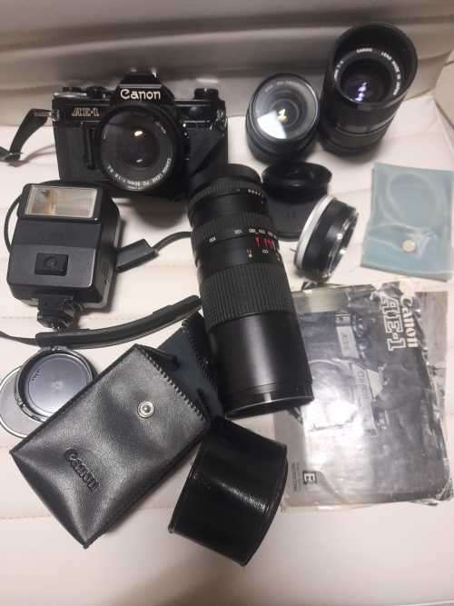 Canon AE1 35mm SLR Film Camera Black camera with 4 lenses. The camera and lenses look to be in very
