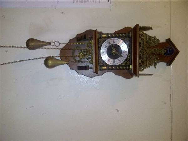 A Dutch WALL CLOCK, surmounted with the figure of Atlas, with two weights and pendulum.