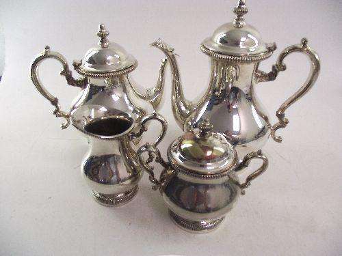 A FOUR PIECE SILVER ON COPPER TEA SET, coffee pot, tea pot, sugar bowl and milk jug