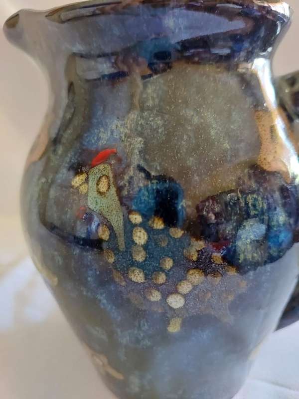 A hand painted lustre pottery jug with guinea fowl