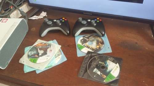 xbox 360 with 2 controllers and all cables and plays pirated games