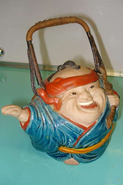 A Very unusual Antique Buddah Chinese earthenware tea pot and lid with bamboo handle