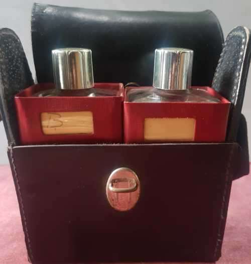 Vintage Scotch and Bourbon bottles in a black leather travel case with handle.