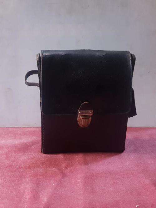 Vintage Scotch and Bourbon bottles in a black leather travel case with handle.