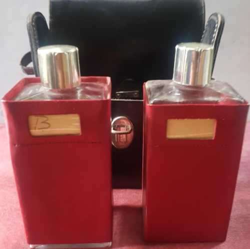 Vintage Scotch and Bourbon bottles in a black leather travel case with handle.
