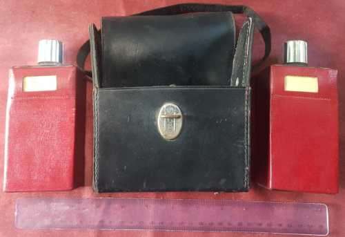 Vintage Scotch and Bourbon bottles in a black leather travel case with handle.