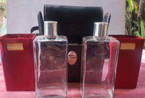 Vintage Scotch and Bourbon bottles in a black leather travel case with handle.