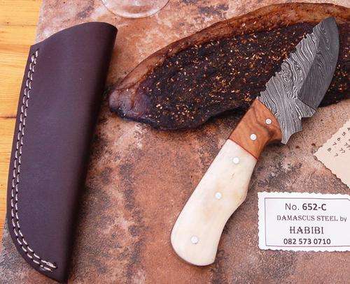 Damascus steel Biltong Knife. Brass/Bone/Wood, leather sheath. Was R 1950.00. NOW ONLY R899.00