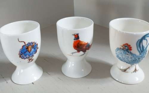 THREE HANDPAINTED EGG-CUPS BY JANE ABBOTT