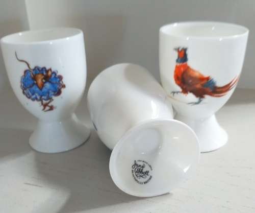 THREE HANDPAINTED EGG-CUPS BY JANE ABBOTT