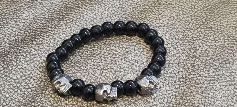 Black onyx stone bead stretch bracelet with 3 skull charms