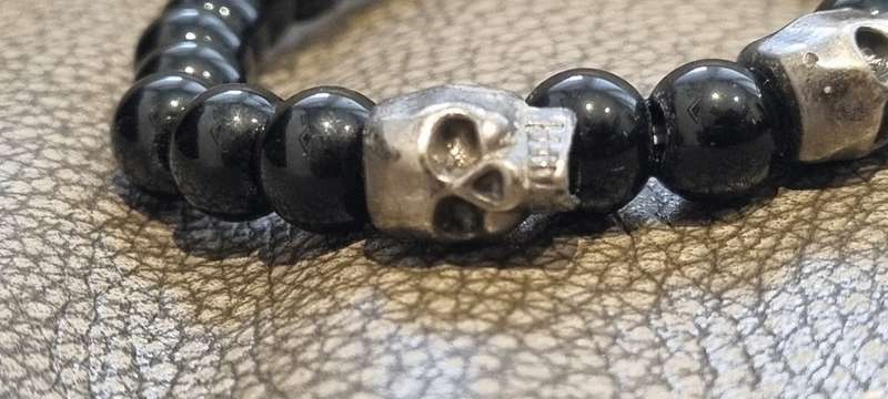 Black onyx stone bead stretch bracelet with 3 skull charms