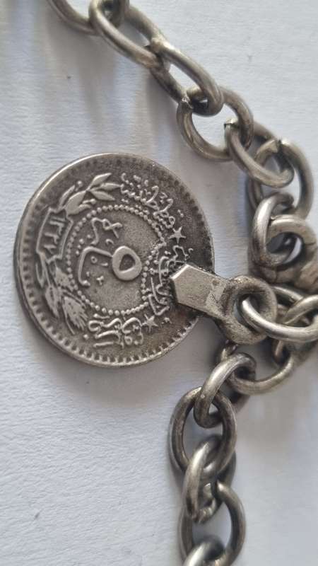 All metal necklace. Brass 9 discs and coin at clasp.
