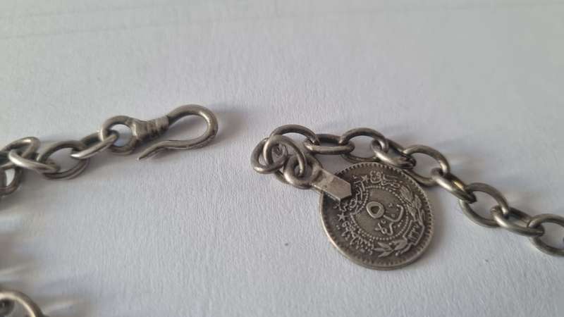 All metal necklace. Brass 9 discs and coin at clasp.
