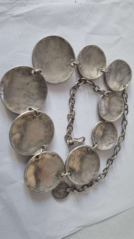 All metal necklace. Brass 9 discs and coin at clasp.