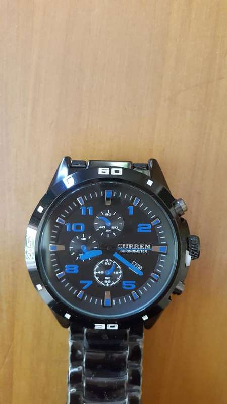 NEW  Curren Watch. Dial, black face and blue hands. With tag, sealed.
