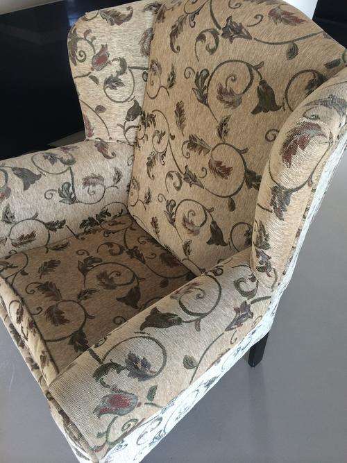 Cream colored wingback chair