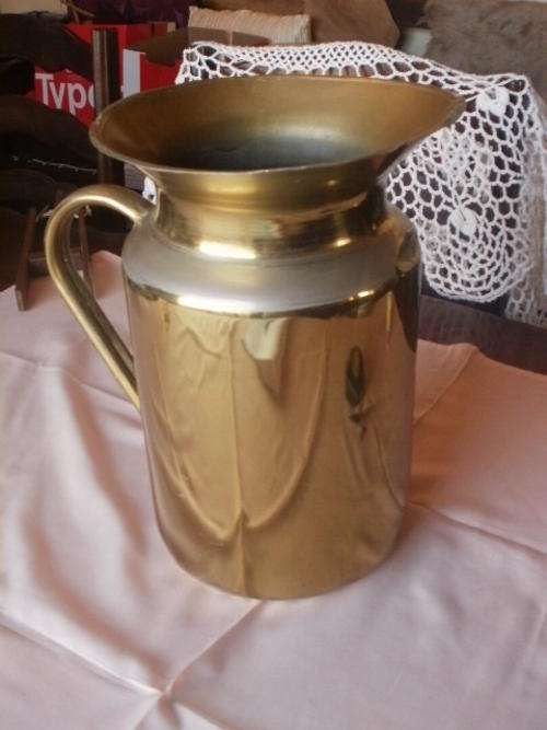ENAMEL JUG THAT HAS BEEN BRASSED