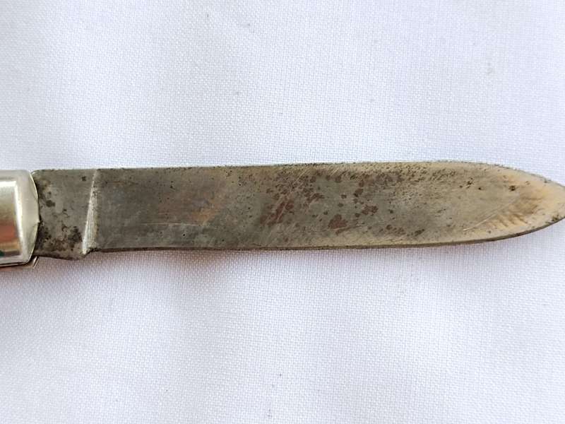 Three vintage pocket knifes two with animals and one union building